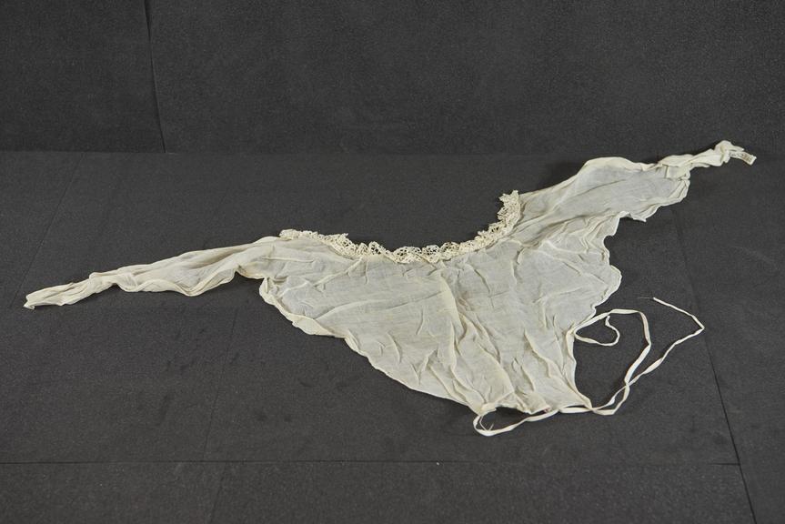 Cream modesty bodice of fire muslin with lace edging at neck