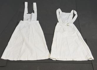 Two White Linen Aprons with Square Bibs and Cross Straps.