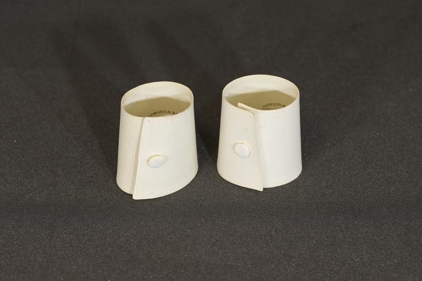 Pair of stiffened white linen cuffs with pearl buttons