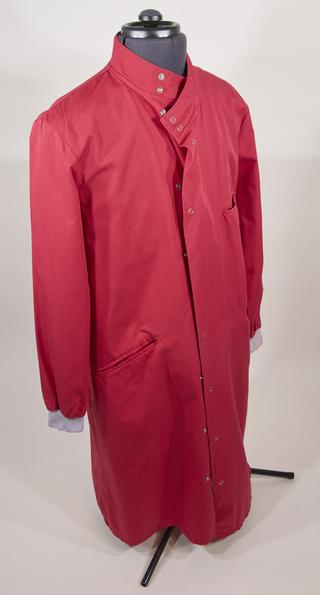 Red lab coat worn by people working at the Alderley Park Lighthouse Lab