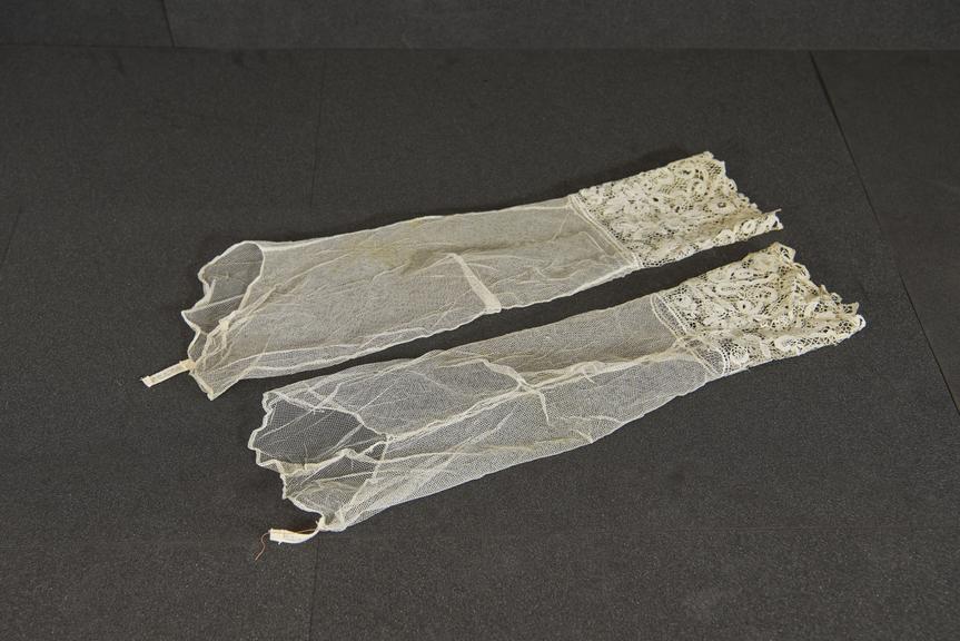 Pair of lace cuffs attached to mesh sleeves