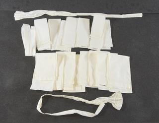 Sixteen white cotton bands for securing caps in a bow under chin