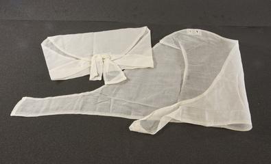 Two white voile triangular caps with slight decorative edging