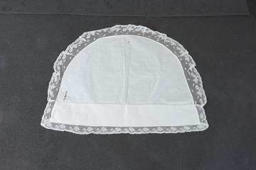 White cotton cap with lace edging in a floral design