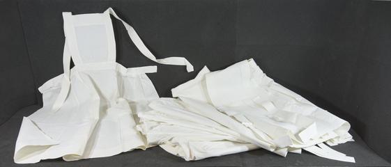 Seven SRN white linen aprons