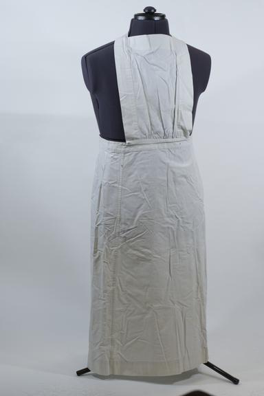 White linen apron with square bib and cross-straps