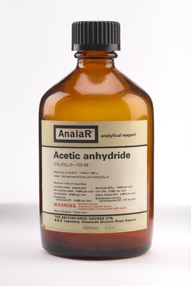 An empty brown glass bottle for acetic anhydride.