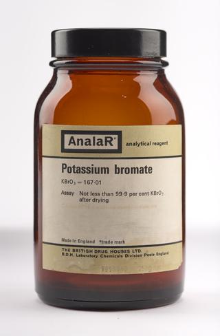 An empty brown glass bottle for potassium bromate.
