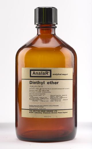 An empty brown glass bottle for diethyl ether.