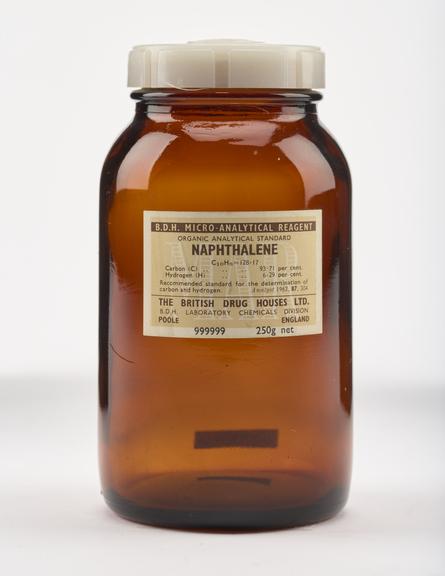 An empty brown glass bottle for naphthalene.