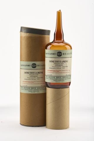 An empty brown glass ampoule for dimethylamine.