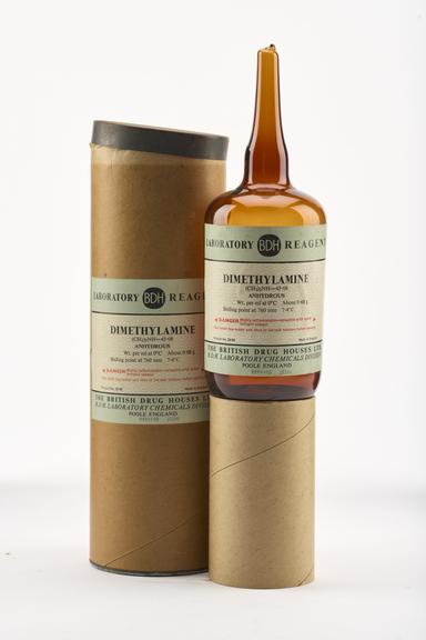 An empty brown glass ampoule for dimethylamine.