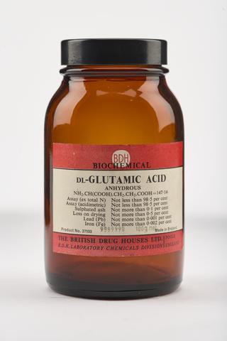 An empty brown glass bottle for dl-glutamic acid.