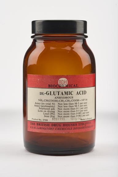 An empty brown glass bottle for dl-glutamic acid.