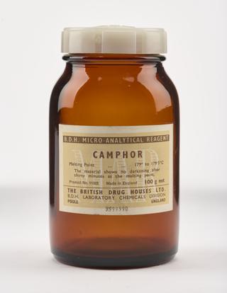 An empty brown glass bottle for camphor.