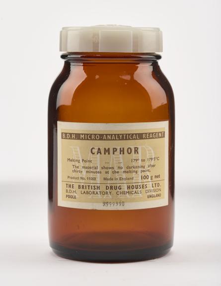 An empty brown glass bottle for camphor.
