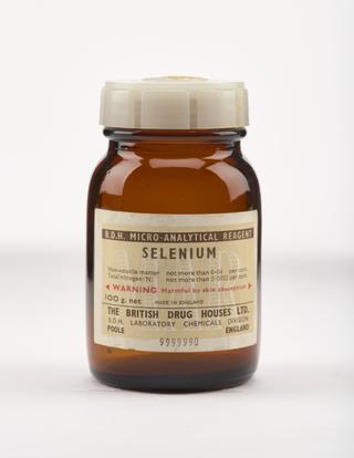 An empty brown glass bottle for selenium.