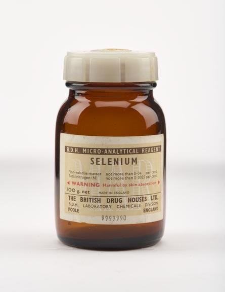 An empty brown glass bottle for selenium.