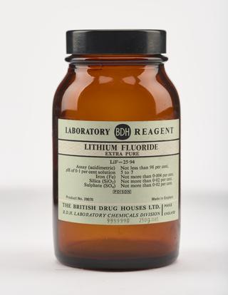 An empty brown glass bottle for lithium fluoride.