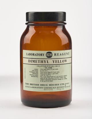 An empty brown glass bottle for dimethyl yellow.