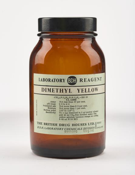 An empty brown glass bottle for dimethyl yellow.