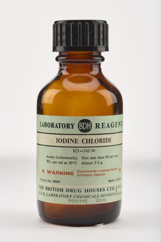 An empty brown glass bottle for iodine chloride.