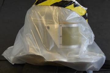 Glassfibre polyester resin helmet for aluminised asbestos fire suit