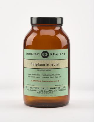 An empty brown glass bottle for sulphamic acid.