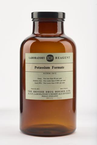 An empty brown glass bottle for Potassium Formate.