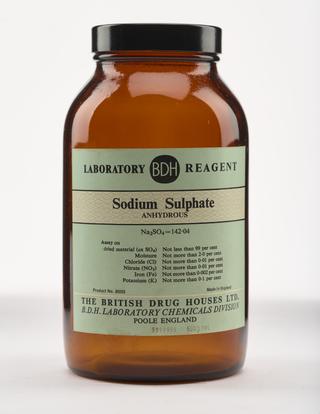 An empty brown glass bottle for sodium sulphate.