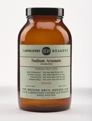 An empty brown glass bottle for sodium arsenate.