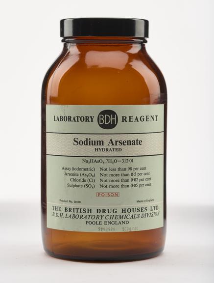 An empty brown glass bottle for sodium arsenate.