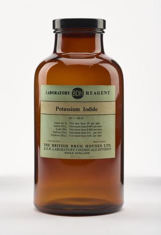 An empty brown glass bottle for potassium iodide.
