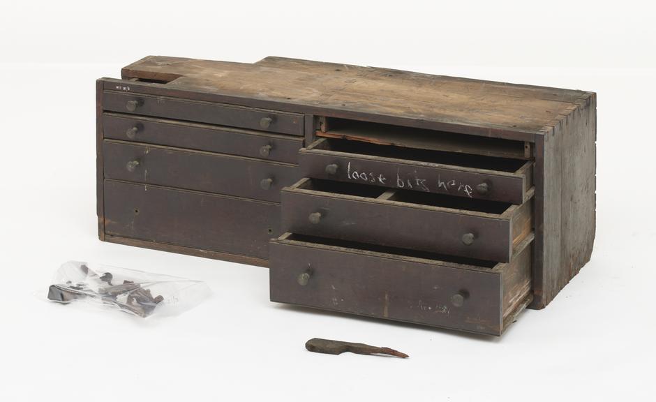 A pair of wooden drawer cabinets for tool storage