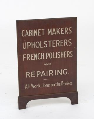 Polished shop sign with painted lettering