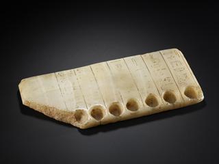 Stone slab with seven wells for sacred oils, Egypt, 2040 - 1782 BCE