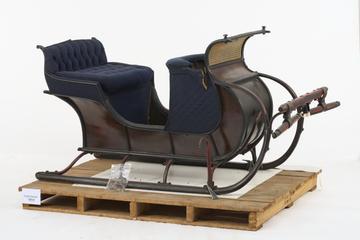 Red wooden sleigh with blue upholstery