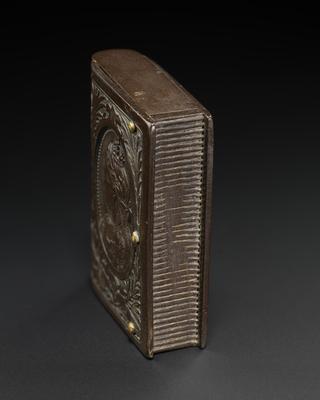 Black vulcanite match holder in book form with spring hinged lids top and bottom