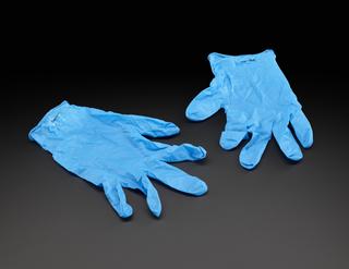 Dark blue gloves worn as PPE by people testing COVID-19 samples