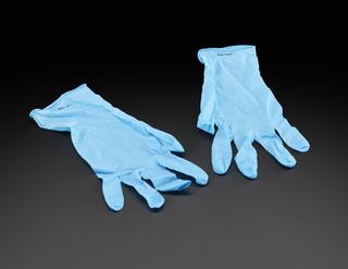 Light blue gloves worn as PPE by people testing COVID-19 samples