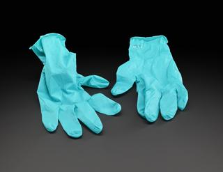 Green gloves worn as PPE by people testing COVID-19 samples