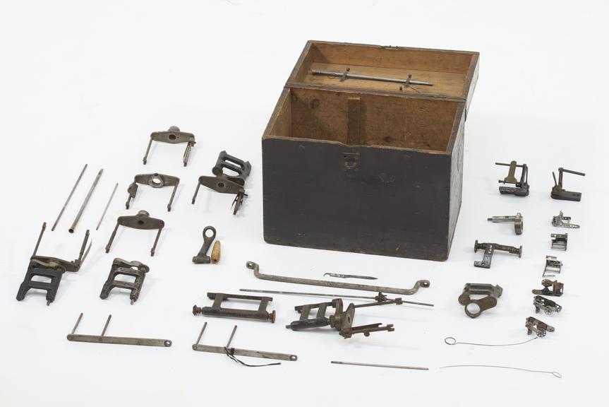 Box containing attachments for embroidery heads
