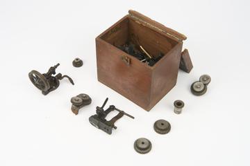 Box containing spare parts and gear wheels