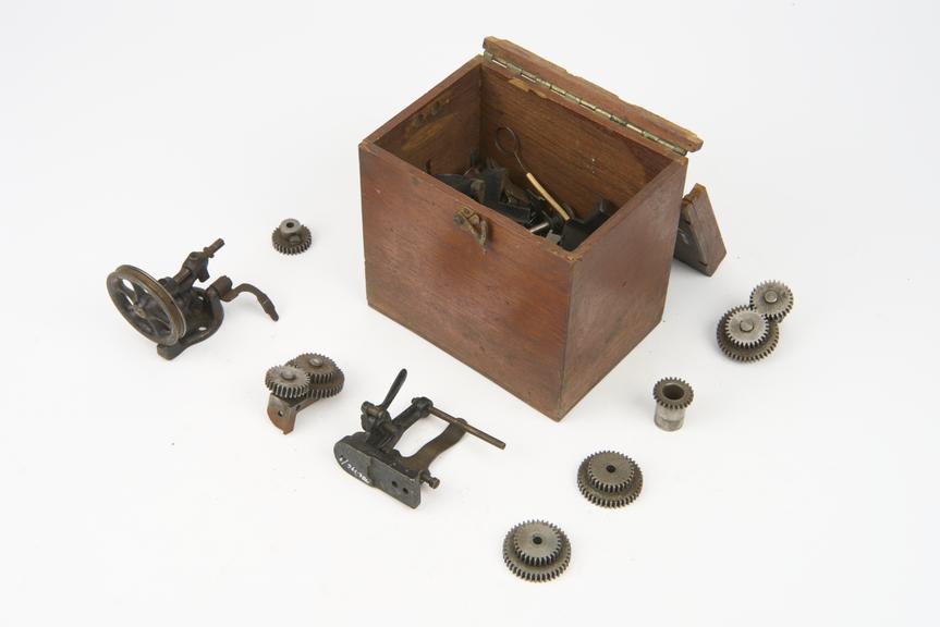 Box containing spare parts and gear wheels