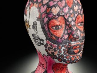 Decorated mannequin head used as a wig stand, associated with an individual's cancer diagnosis, 2016.