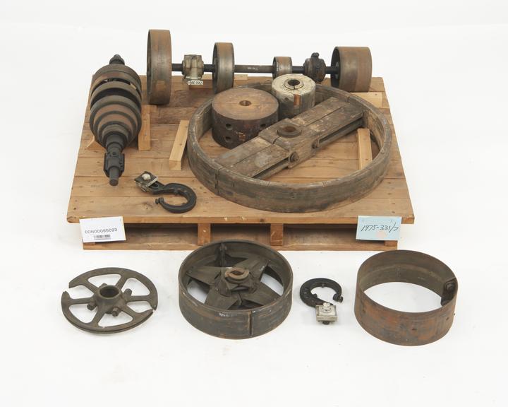 A countershaft with 2 plummer blocks and 4 pulleys; a counter shaft with 4-step pulleys