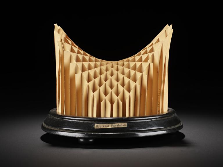 Assembled cardboard geometrical model on wooden display stand