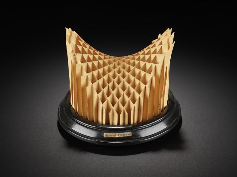 Assembled cardboard geometrical model on wooden display stand