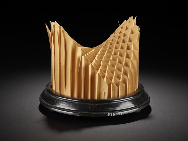 Assembled cardboard geometrical model on wooden display stand