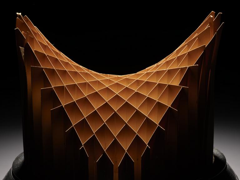 Assembled cardboard geometrical model on wooden display stand